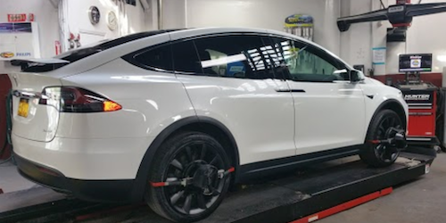 ASE trained and certified Master auto repair Technicians perform wheel alignment on Tesla vehicle at Precision Auto Works of Long Island City, NYC 11101
