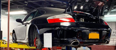 Porsche on the lift at Precision Auto Works Auto Repair Shop 11101.